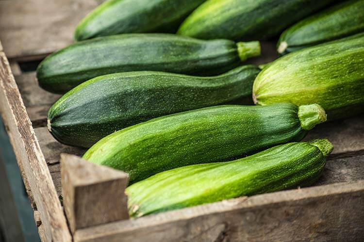 zucchinis in a wooden crate 