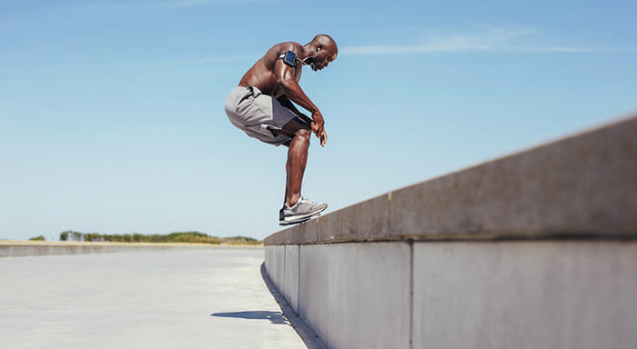 Man balancing on wall, working out 