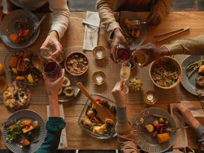 Above view background of multi-ethnic group of people enjoying feast during dinner party with friends and family