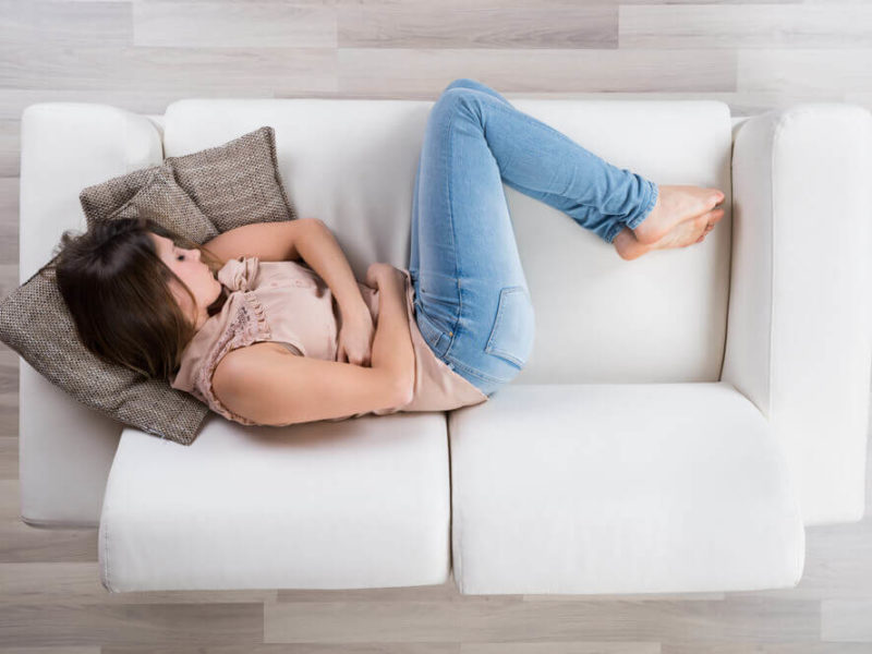 photo of woman napping on couch