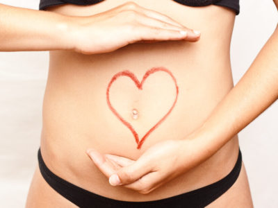 photo of heart drawn over a woman's stomach to represent gut health