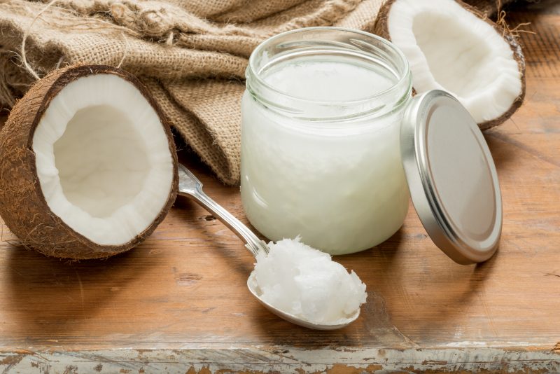 Coconut and jar of coconut oil
