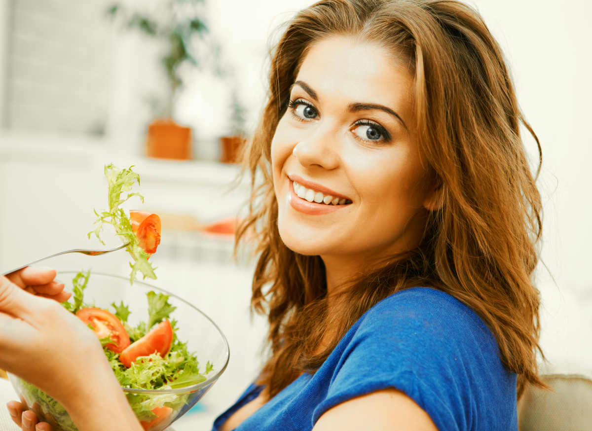 Sitting on sofa at home and eating healthy food | The Link Between Your Poop And Stress Levels