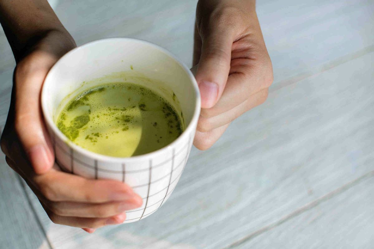 Close up photography of person holding ceramic mug | The Battle Of The Greens: Moringa vs. Matcha | moringa benefits | super greens