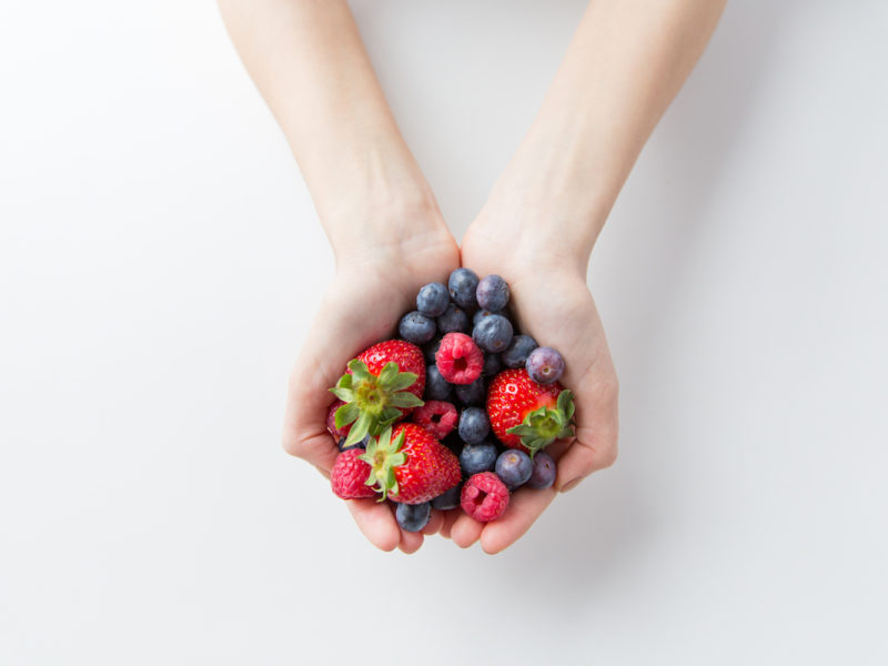 photo of person holding berries in both hands