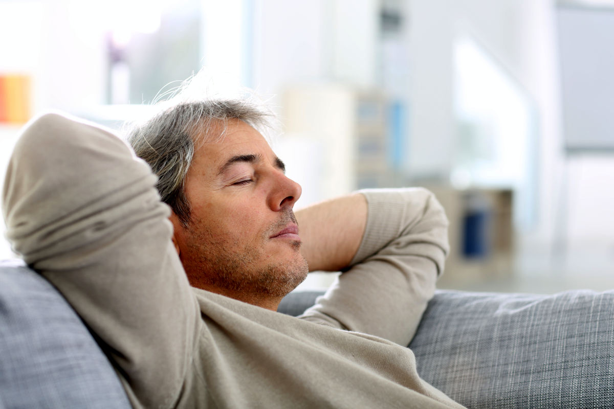 Man taking a nap in sofa at home | 9 Sleep Tips Arianna Huffington Swears By