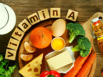 Foods to eat to avoid vitamin A deficiency, orange, broccoli, eggs, cheese, spread across table