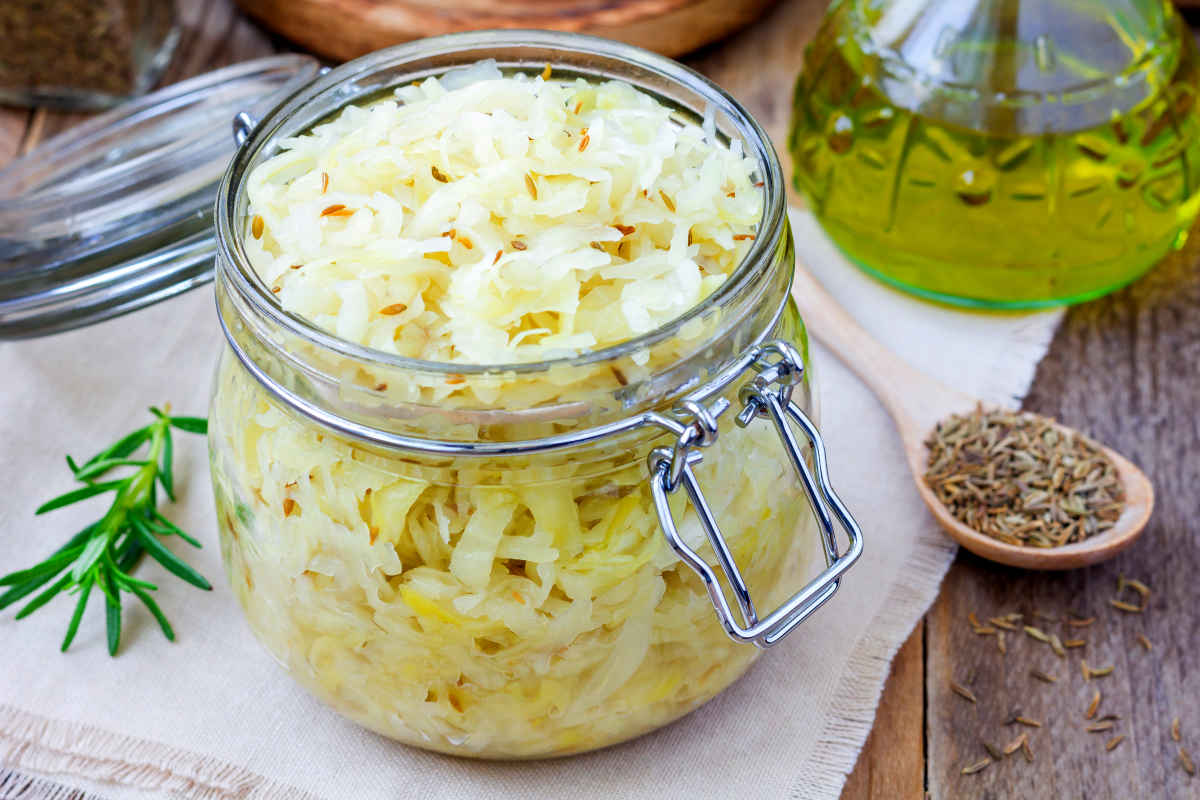 Homemade sauerkraut with cumin in a glass jar | Foods To Add To Your Microbiome Diet