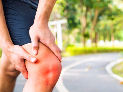 runner holding knee from pain due to too much iron and inflammation