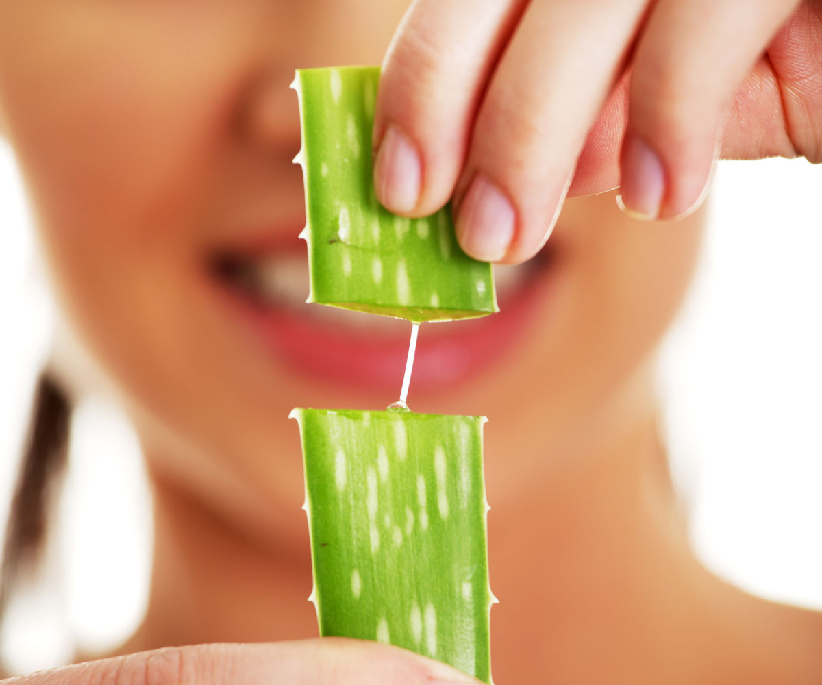 Woman with aloe vera | Best Herbs For Hair Growth At Home