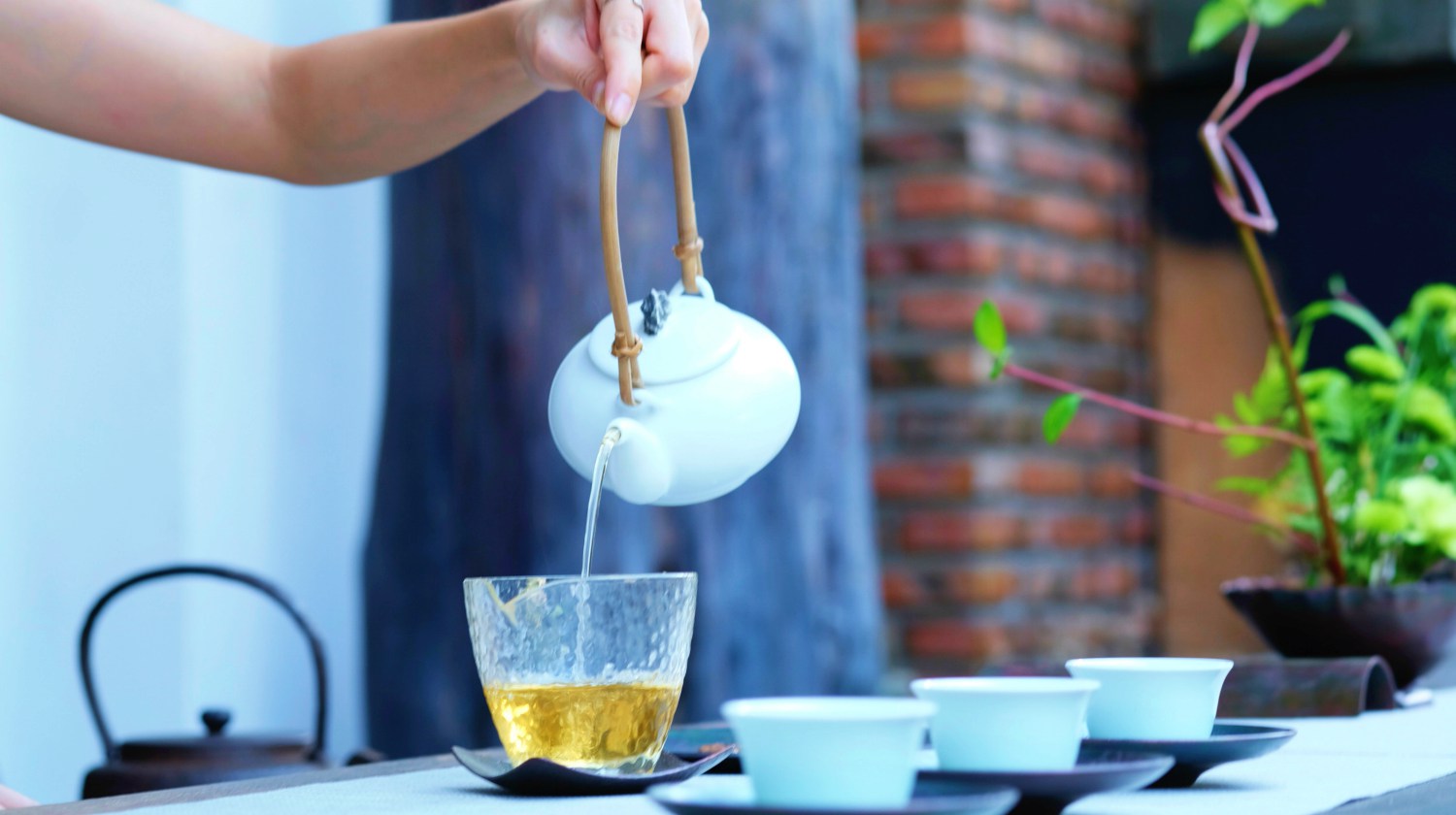 photo of person pouring green tea, an herb for energy and vitality