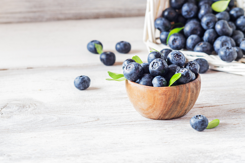photo of a bowl of fresh blueberries on a table