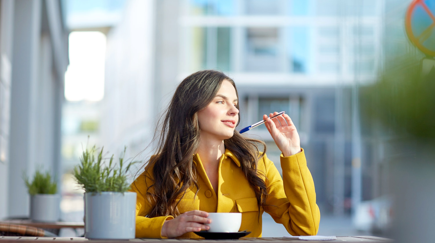 Feature | Happy young woman with cup drinking cocoa and writing | Foods To Boost Your Brain Power