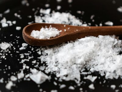 sea salt on surface and in wooden spoon