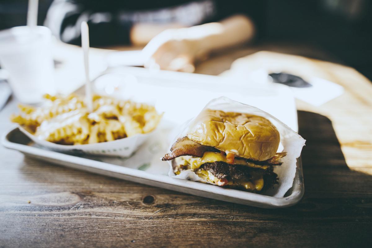 a tray on table with burger and fries | fast food | keto fast food options | fast food chains