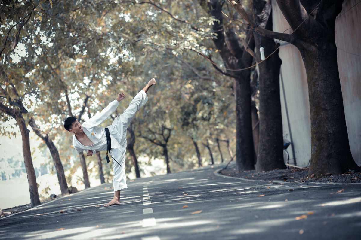 asian young teen man doing karate kick by the street | types of martial arts | types of martial arts self defense | all types of martial arts