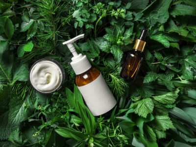 natural sustainable beauty products on background of green plants