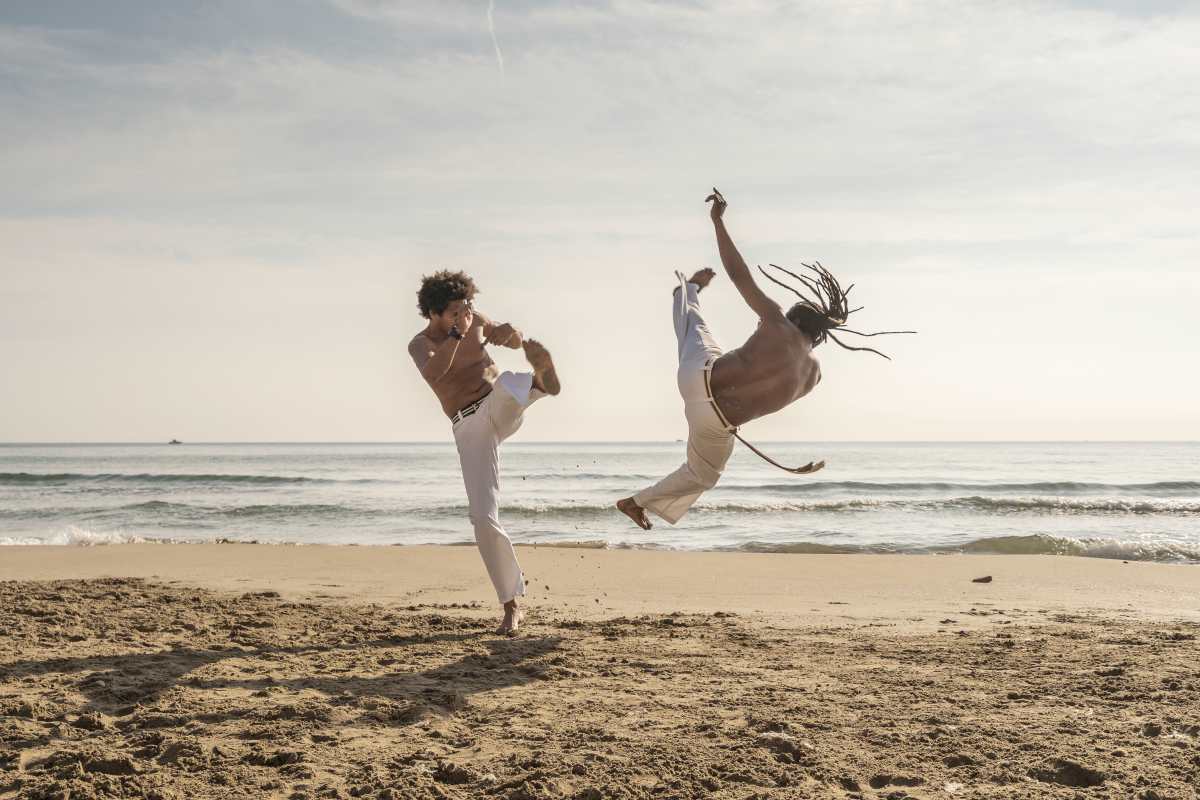 two men doing capoeira by the beach | types of martial arts | how many types of martial arts are there