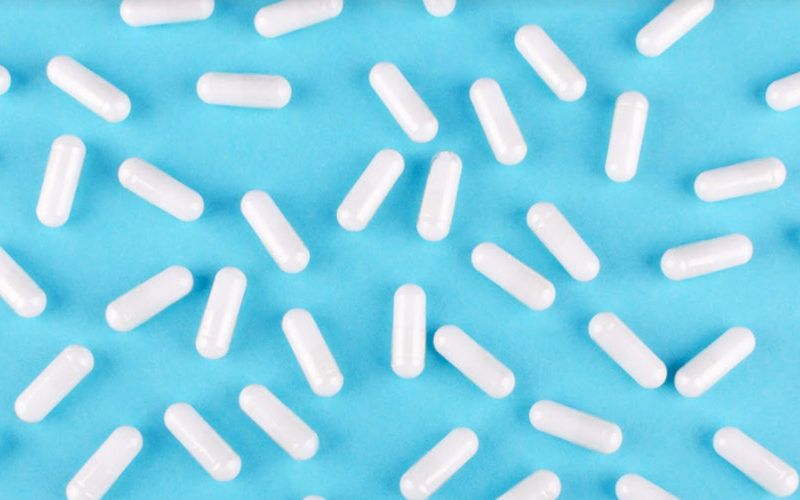 photo of vitamins spread out on a blue background