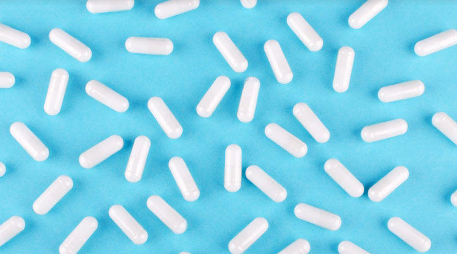 photo of vitamins spread out on a blue background