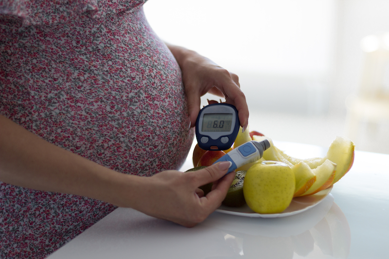 photo of woman with gestational diabetes checking blood sugar level