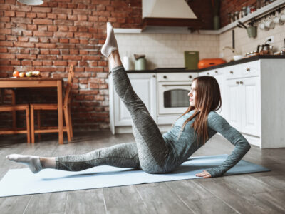 young woman practicing isometric exercises at home