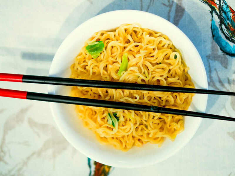 ramen noodles in bowl with chopsticks on top