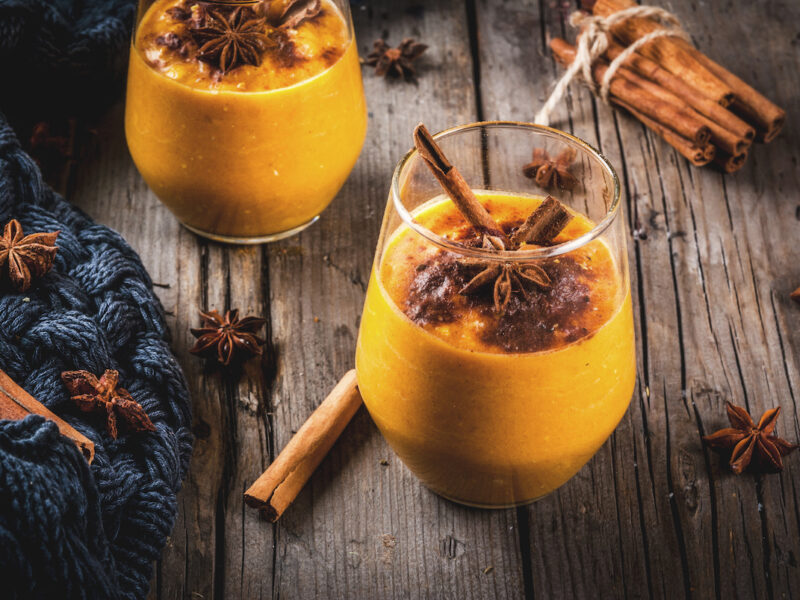 Traditional autumn dishes, spicy pumpkin pie smoothie with cinnamon, anise and oatmeal. In portioned glasses, on rustic wooden old table. 