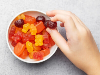 Photo of child's hand reaching for fruit snacks