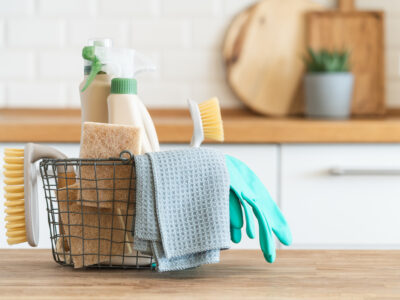 photo of basket of cleaning supplies sitting on a counter; fall cleaning concept