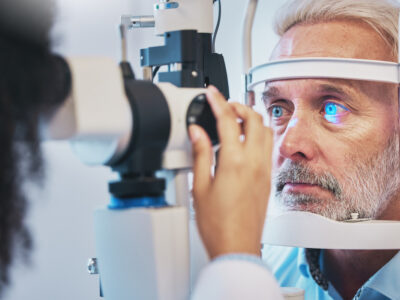 Ophthalmology, medical and eye exam with older man and consulting for vision, healthcare and age-related macular degeneration checkup