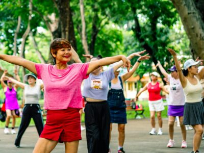 Group of older women exercising together in a park; longevity training concept